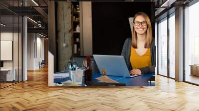 A girl works at a computer in a modern office Wall mural