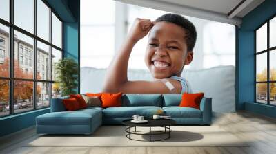 African boy kid, vaccine and portrait with smile, medicine and flex muscle for wellness in hospital. Male child, strong and excited with plaster for injection, healthcare and injection to stop virus Wall mural