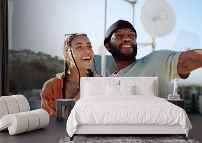 Couple, bonding or talking on city rooftop and pointing, sightseeing Portugal or enjoying summer holiday vacation view. Smile, happy and love black man and interracial fashion woman on location date Wall mural