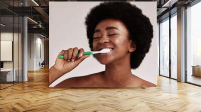 Toothbrush, brushing teeth and black woman for clean and healthy mouth on studio background. Face of person advertising dentist tips for dental care, whitening and cleaning with a hygiene smile Wall mural