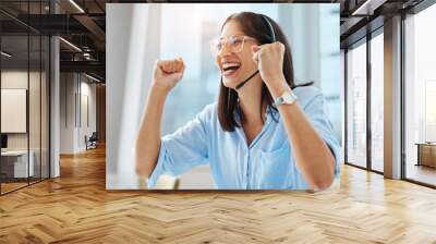 Another brilliant review from a client. Shot of an attractive young call centre agent sitting alone in her office and feeling successful. Wall mural