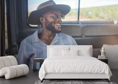 Comic, happy and black man on a road trip in van during holiday on the countryside of California. Thinking, relax and free person with smile in car during vacation in nature for travel and adventure Wall mural