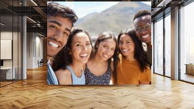 Friends become our chosen family. Portrait of a group of young friends hanging out together outdoors. Wall mural