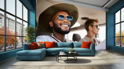 Happy, smile and black man driving a car while on a summer road trip vacation with friends. Happiness, freedom and young people having fun while traveling in a vehicle to holiday destination together Wall mural