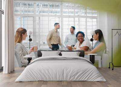 Happy, smiling and friendly colleagues talking on their coffee break or meeting about the news and gossip. Young, global and diverse female employees enjoying their discussion in the staff room Wall mural