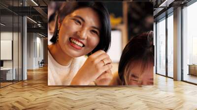 Japanese friends, laughing and talking in restaurant for dinner, vacation and hungry to order healthy food. Women, man or happy together on lunch in tokyo city or funny joke by bonding in coffee shop Wall mural