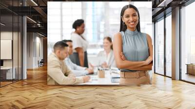 Smiling, happy and motivated young business woman with arms crossed showing great leadership to her team in an office. Portrait of confident and proud entrepreneur satisfied with growth in a startup Wall mural