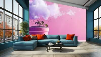 Pink plant pot under a surreal blue exploding cloud on a pink background in banner format Wall mural