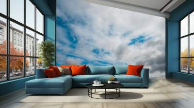 Blue sky with white soft clouds. Pleasant warm summer weather. Wall mural