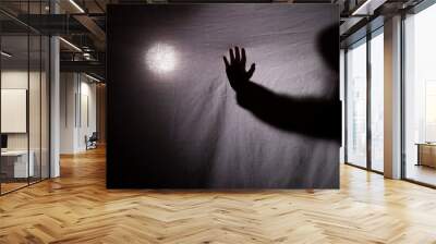 halloween. a shadow or silhouette of two hands, with a white cloth. in transparency with space to copy your text Wall mural