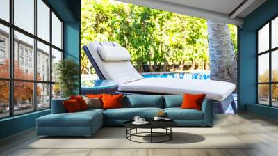 Empty chair deck lounge around swimming pool in hotel resort Wall mural