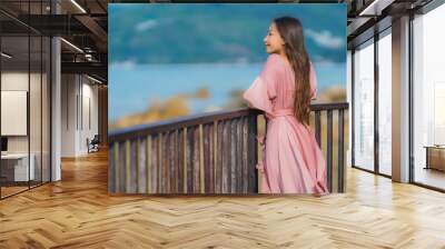 Portrait beautiful young asian woman looking sea beach ocean for relax in holiday vacation travel Wall mural