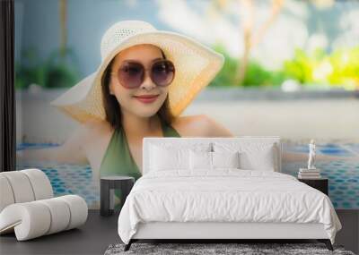 Portrait beautiful young asian woman relax around swimming pool in hotel resort Wall mural