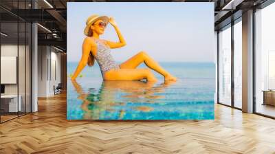 Portrait beautiful young asian woman relax smile enjoy leisure around swimming pool Wall mural