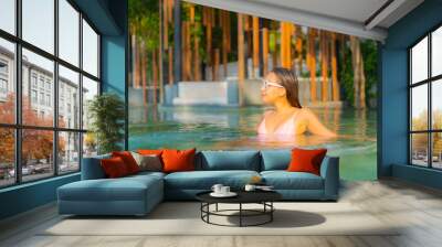 Portrait beautiful young asian woman relax smile enjoy leisure around swimming pool Wall mural