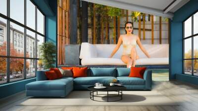 Portrait beautiful young asian woman smile happy relax around swimming pool in hotel resort for leisure Wall mural