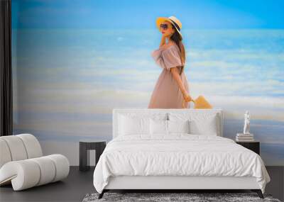 Portrait beautiful young asian woman smile happy walk on the tropical outdoor nature beach sea Wall mural