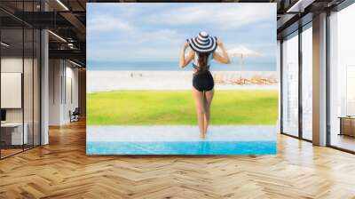 Portrait beautiful young asian women happy smile relax around swimming pool Wall mural