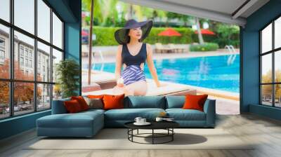 Portrait beautiful young asian women happy smile relax around swimming pool Wall mural