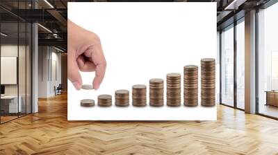 Male hand putting money coin stack growing business isolated on white background Wall mural