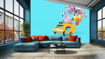 3d bus or van on podium with guitar, luggage, balloons, camera, sunglasses, flower, umbrella, flamingo isolated on blue background. summer travel concept, 3d render illustration Wall mural