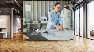 Beautiful fashion old woman designer standing in studio. Old woman fashion designer working in studio Wall mural