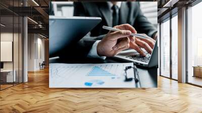 Close up of two businessmen using digital tablet and laptop working analytic business reports at workplace, Business people discussing plan new project, chart, graph, marketing and financial concept. Wall mural