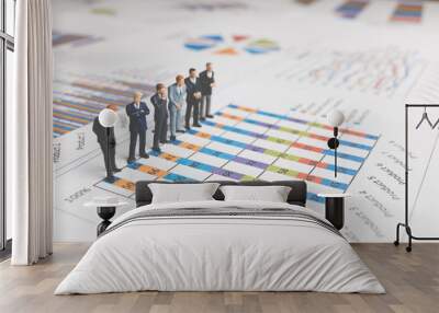 Miniature People : Businessman standing on a Paper graph chart ,Developing a teamwork concept Wall mural