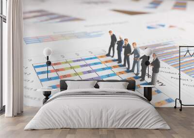 Miniature People : Businessman standing on a Paper graph chart ,Developing a teamwork concept Wall mural