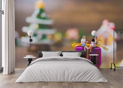 Miniature people on gift box with Christmas Day celebration background Wall mural