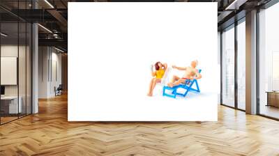 Miniature people sunbathing on deck chairs on white background , Summer time concept Wall mural