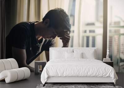 Sad man lying on the floor full of desperation thoughts .Portrait of thoughtful sad man alone. Fear, sadness, abuse, depression, addiction. Wall mural