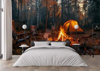 Beautiful bonfire with burning wood near chairs and camping tent in the forest. Campfire next to chairs and tent Wall mural