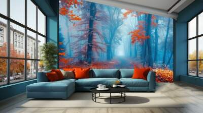 Beautiful mysterious forest in the blue autumn mist. Colorful landscape with enchanting trees with orange and red leaves. Landscape with a path in a dreamy misty forest Wall mural