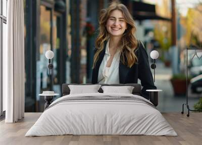 Photo of a smiling, happy professional business woman. Positively confident female entrepreneur standing outdoors on the street in a bag, looking at the camera Wall mural