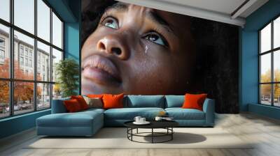 Photo of Touched by His Grace, a beautiful black woman looking up with tears in her eyes, Christian concept. Wall mural