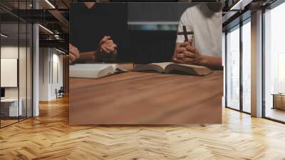 Christian group are praying to god with the bible and sharing the gospel. Concept of faith for god. Wall mural