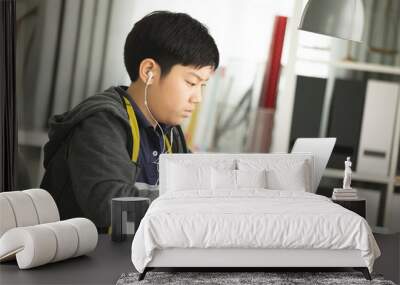 Asian preteens doing your homework with laptop. Wall mural