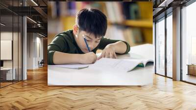 Happy asian child doing homework with smile face. Wall mural