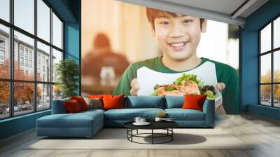 Healthy lifestyle asian child showing salad smiling. Wall mural