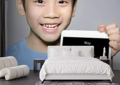 Little Asian boy hands holding the tablet computer with Success Wall mural