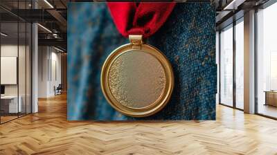 A close-up of a gold medal hanging from a red ribbon. Wall mural