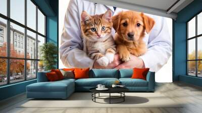 Adorable ginger puppy and kitten cuddle together in a veterinarian's hands, set against a clean white background with ample copy space for text or graphics. Wall mural