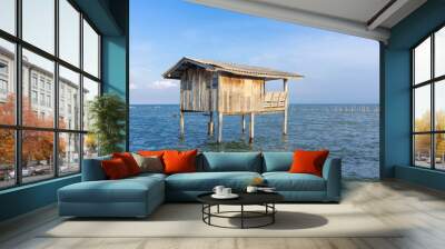 Wooden timber houses on stilts in water sea with clear blue sky near coast,home of fishing village for fisherman Wall mural