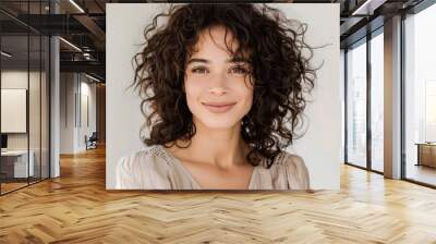 Woman with curly hair styled in voluminous curls, looking joyful, wearing a casual dress, Portrait half-body, hyper-realistic, high detail, photorealistic, white background, studio lighting, Key Wall mural