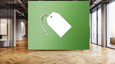 Blank white paper sale tag on green texture background, business concept background Wall mural