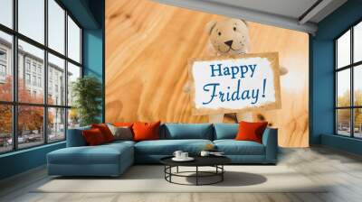 Cute little bear doll with Happy Friday card on wooden table, greeting card idea Wall mural