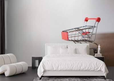 Empty shopping cart on wooden talbe with space on white background, business concept,  Wall mural