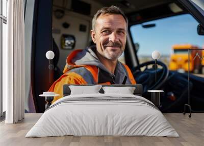 Industry truck driver in hard hat on background cabin of his lorry. Wall mural