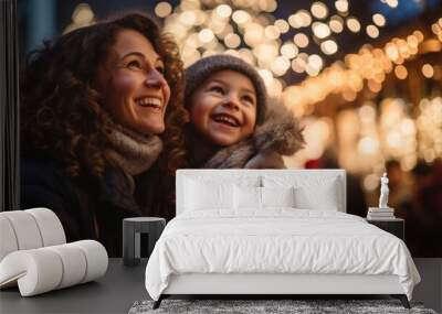 Mother and child having wonderful time on traditional Christmas market on winter evening. Wall mural